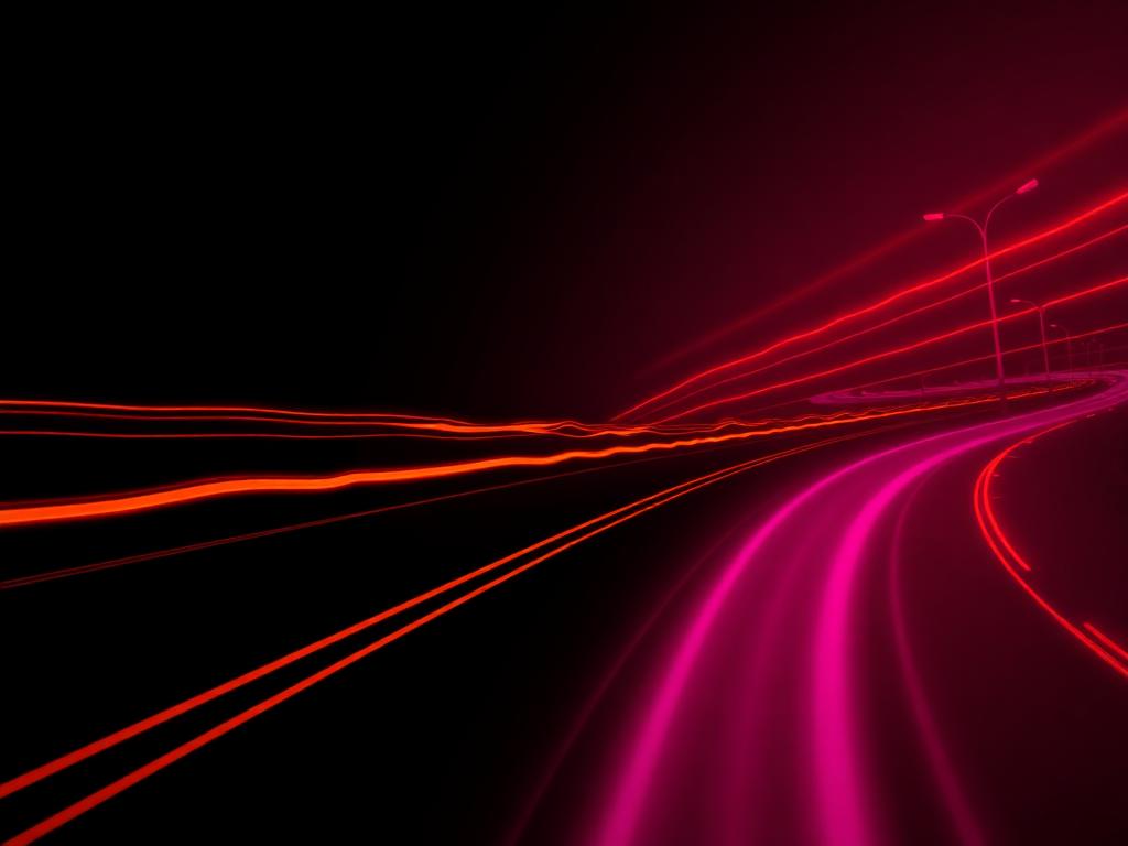 Neon orange and magenta light trails on a dark highway, representing the Detour cannabis brand aesthetic